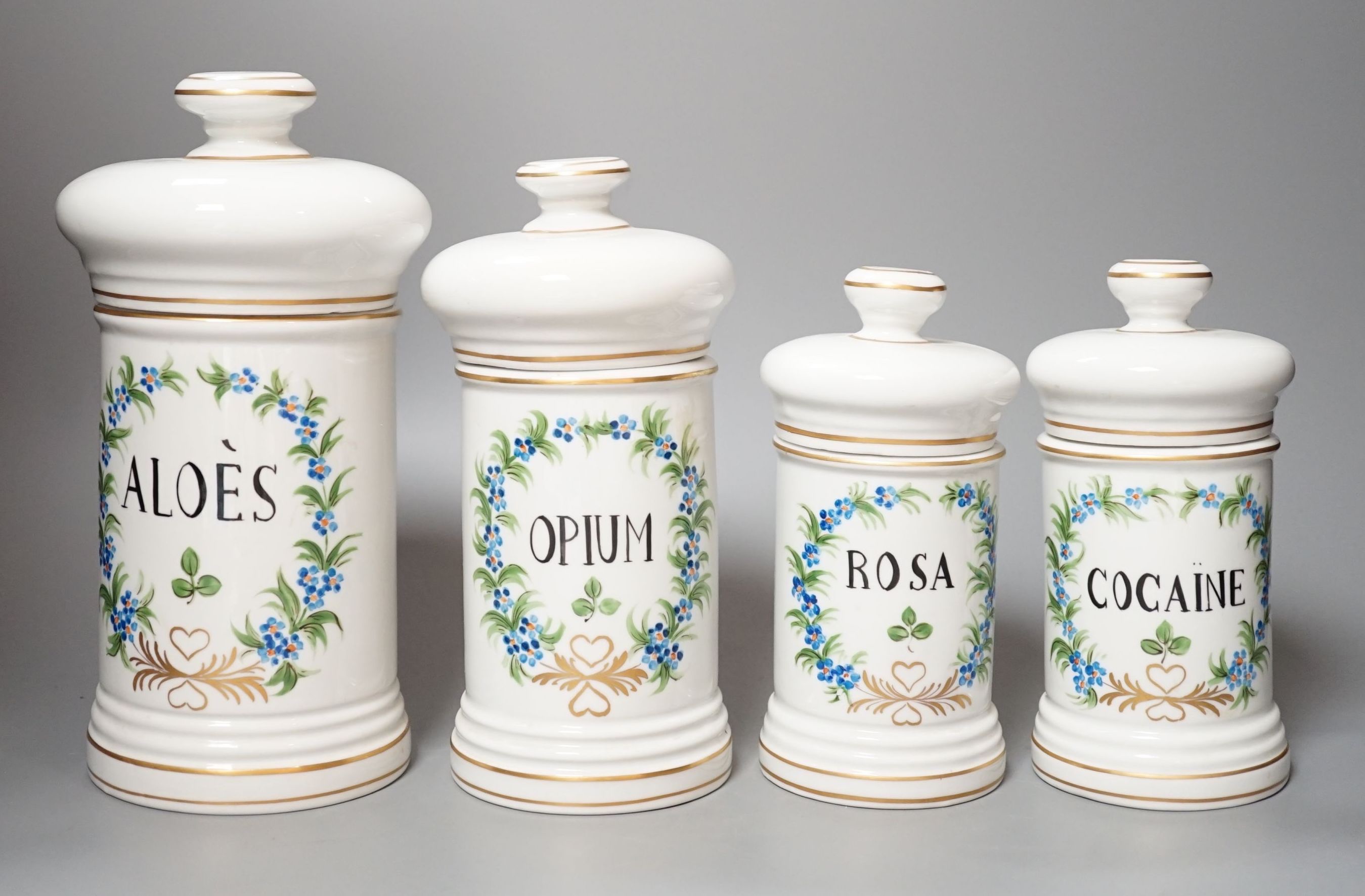 Four graduated porcelain apothecary jars - tallest 26cm